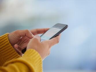 person typing on smartphone